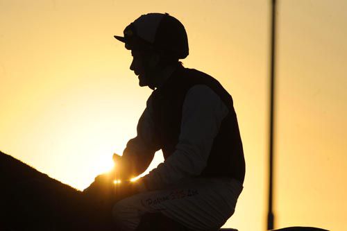 The silhouette of Pat Smullen against the setting sun at Dundalk in 2010