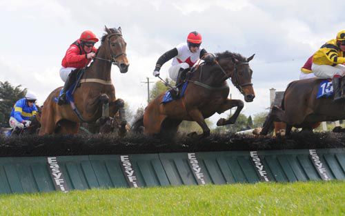 Kilcross Boy (centre) jumps the last before running on strongly to score under Paddy Kennedy