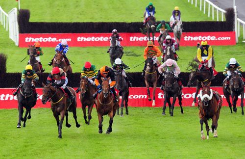 Bob Lingo (yellow cap) gets closer as they clear the last in the Galway Plate