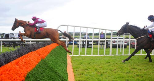 Georgie, in red, jumps the last in second at Galway before staying on well to win