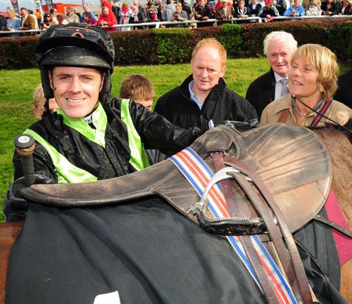 Andrew McNamara unsaddles Shadow Eile after her win with winning trainer Dot Love to the right of picture