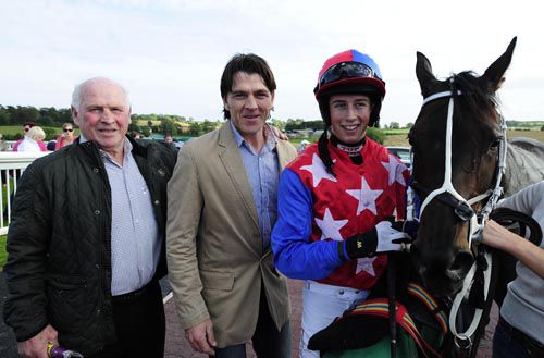 Owners Thomas and Keith Fetherston with Bryan Cooper and Rare Symphony after her win