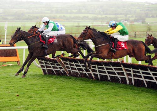 Back To Drumdeel leads Cool Oscar (nearside, winner) over the last at Punchestown