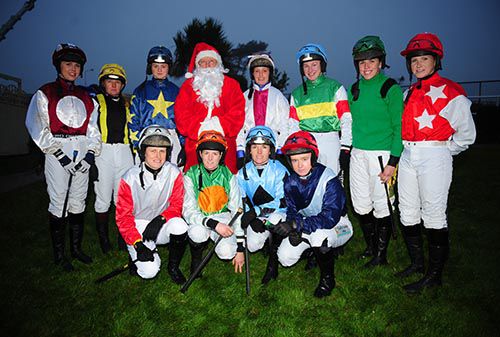 The lady riders in the bumper pose with Santa
