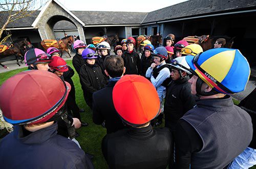 Aidan O'Brien (back to camera, centre) gives out the instructions to his work riders
