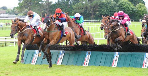 Prince Rudi, red cap, comes through to win the feature in Ballybrit
