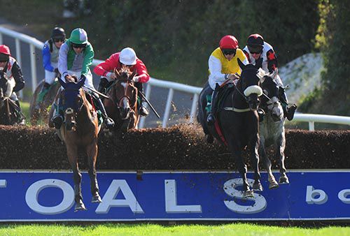 Obispo (second from right, red cap) jumps the second last fence