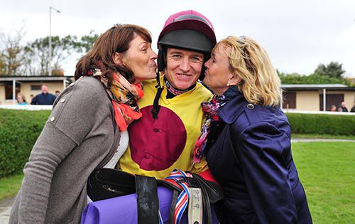 Barry Geraghty gets a kiss from Marie Cronin (left) and Ann McCarthy after Stonehall Jack won for them 