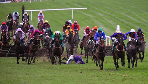 Killeena House (blue with green cap) comes to challenge as Ruby Walsh gets a fall off Queens Wild