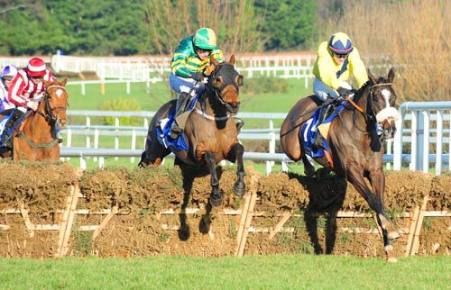 Usuel Smurfer (right) jumps the last just ahead of Off The Charts