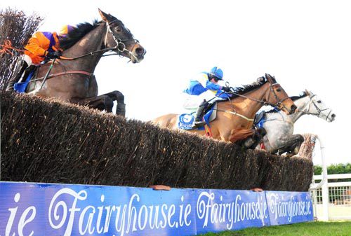 Mr Shankly and Mark Enright (centre) jump the last alongside De Benno (far) and Ballyadam Approach