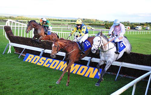 Kilford, centre, has plenty of work to do after jumping the last in Roscommon