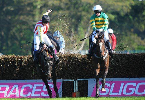 Mark Walsh and Badgerfort (right) clears the last with the erring Vicangelome and Phillip Enright