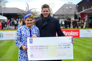 Martina Murphy-Dunne presents the cheque to Robbie's brother Andrew