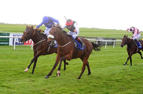 Kevin Manning (blue, left) drives Twilight Payment to success over Forgotten Rules and Pat Smullen