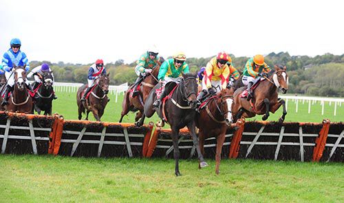 The Fitz Lady and Ruby Walsh (extreme right) jump the last