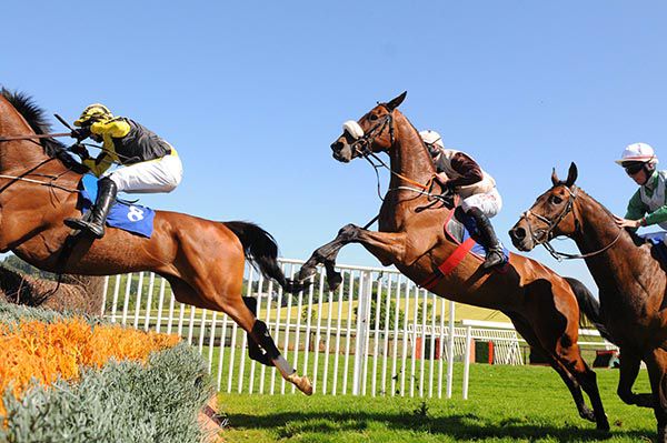 Cecil Corbett and Davy Russell take off at a fence
