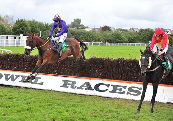 Icantsay (left) jumps past Vinnie Luck at the final fence