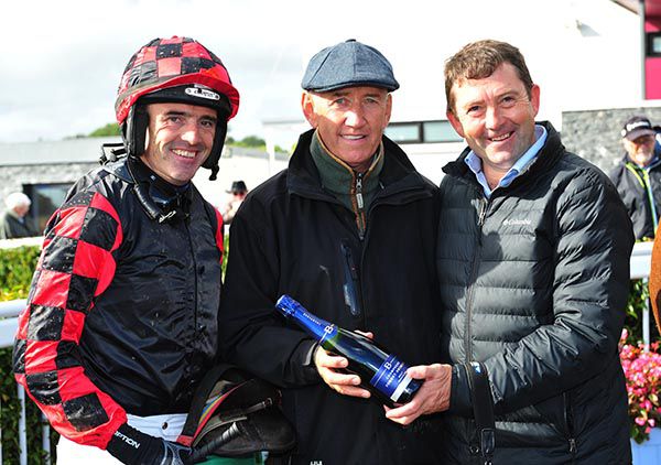 Brendan Sheridan presents a prize to Ruby Walsh and Conor O'Dwyer