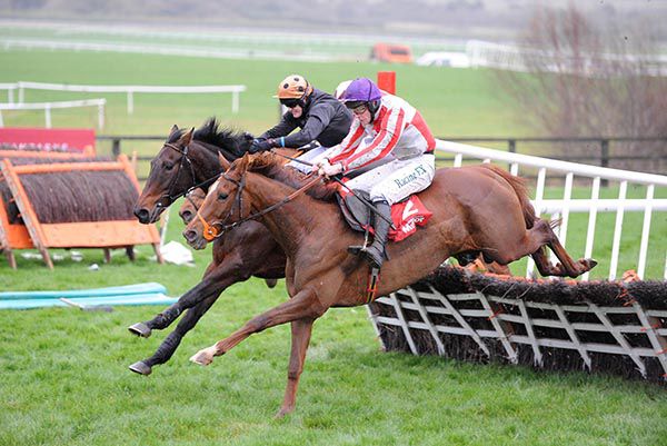 Top Othe Ra and David Mullins (nearest) lands over the last hurdle with Yaha Fizz