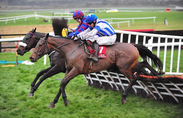 Returntovendor and Ian McCarthy jump the last with Brave Out (nearside) and Denis O'Regan 