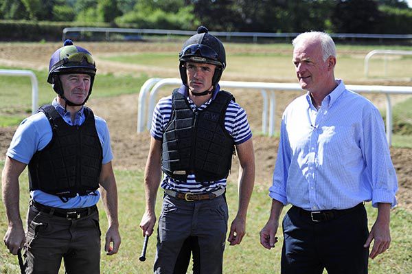 Willie Mullins (right) pictured with two of his work riders