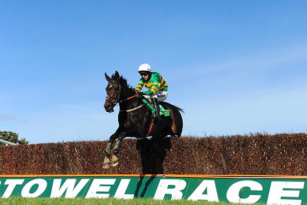      Winter Escape and Mark Walsh jump the last