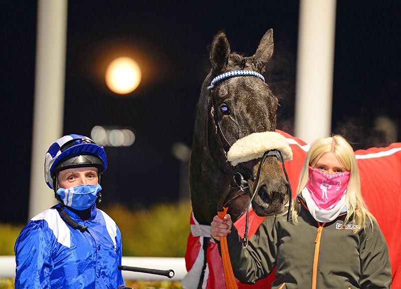 Nawafeth and Chris Hayes with groom Tara McCann and a full moon glowing behind them