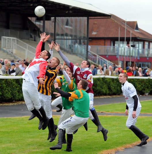Jump jockeys getting in practice ahead of the  Charity Football Match against the Trainers 