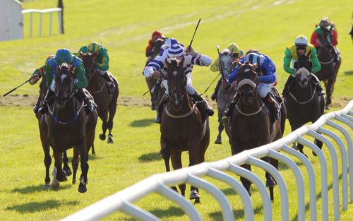 Slade (second from right) battles past Mutamaleq on the rail