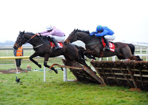 Hurricane Fly (near side) and Paul Townend about to head Solwhit after the last in the 2010 Hatton's Grace Hurdle