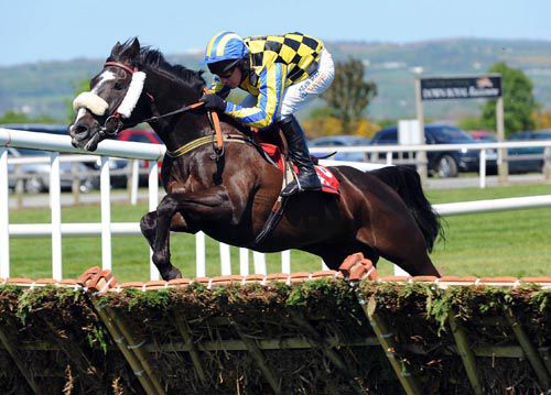 LIKE THE DA and Paul Carberry fly  the last hurdle to win