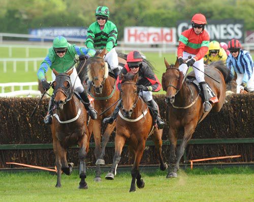 Winner Lion Na Bearnai (centre) leads over the last ahead of runner-up Optimum Force (left)