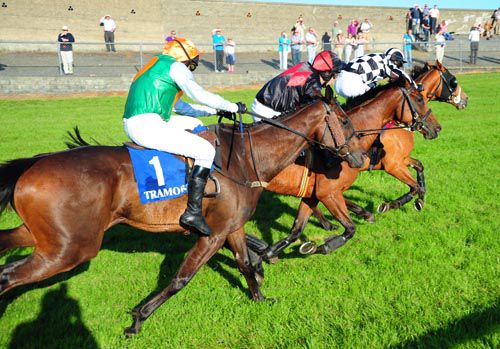 Promise Maker edges to the front as For A Finish's (nearside) jockey Shay Barry is without an iron