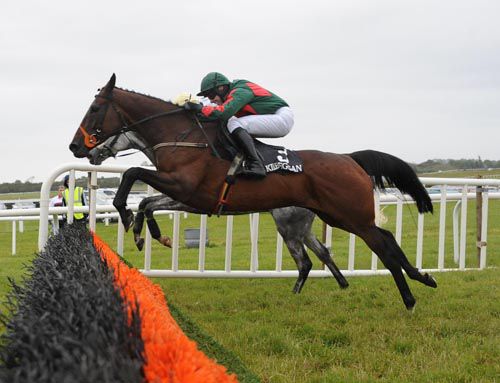 Kalico Kim jumps the last under Declan Bates with the grey Derrinlanna on her inside