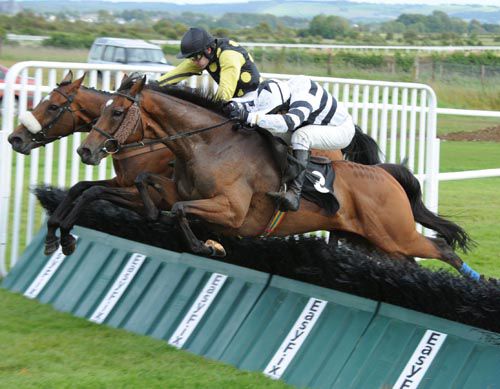 Winner, Safari Sunup (nearest camera) & favourite, Jacksonslady jump the last together