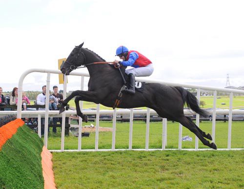 Bobby John puts in a brilliant leap over the last with Declan Bates in the saddle