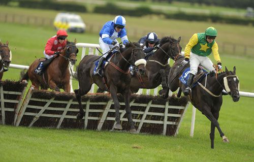 First Beauty, right, leads over the last on her way to victory at Naas