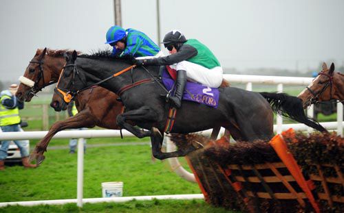 Cash And Go (nearside) and Barry Geraghty jump a flight at Wexford