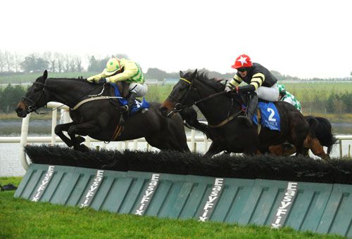 Tell Dawstown and Shay Barry jumping the last hurdle just ahead of Tellherimnothere