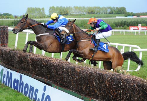 Definite Class under Bryan Cooper jumps the last just ahead of Shop Dj