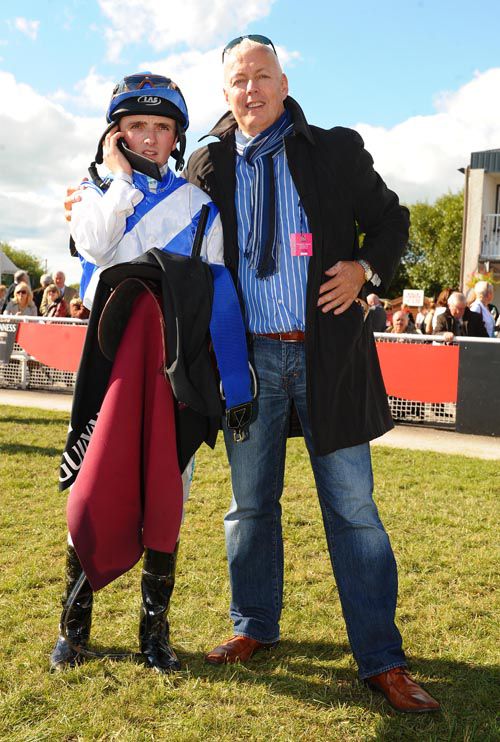 Liam O'Kelly with Chris Hayes talking  to absent trainer Denis Hogan on the phone