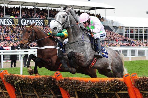 Champagne Fever (right) jumps the last in the William Hill Supreme Novices' Hurdle