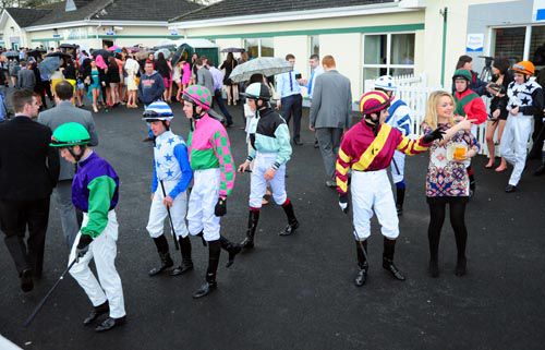 Riders make their way out to the parade ring before the second race on students' raceday