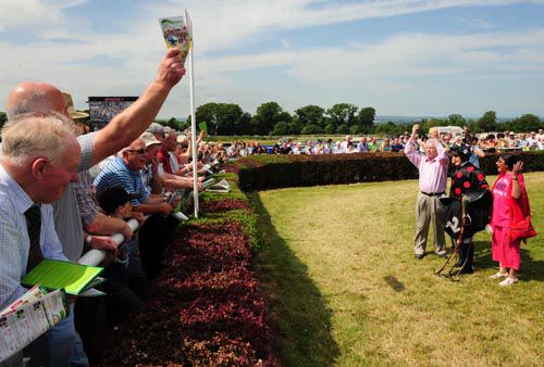 Oliver Brady celebrates in the winners enclosure with Ryan Treacy and Rita Shah