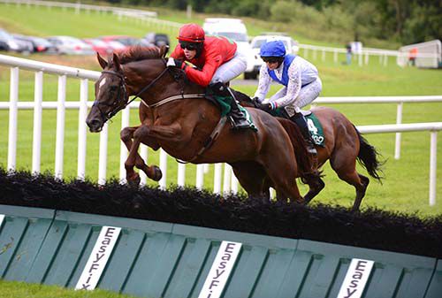 Top Madam clears a hurdle on her way to victory under Harley Dunne