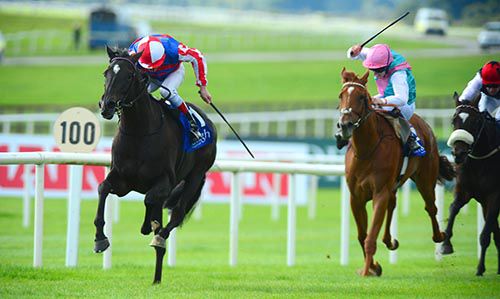 Belle de Crecy is driven out by Johnny Murtagh, with Hot Snap (pink hat) back in second 