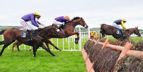 Massini's Trap (orange cap) jumps the last behind the eventual second, King Of The Picts