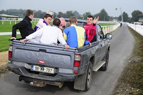 Paddy Graffin (centre) and a group of jockeys travel out to inspect the track