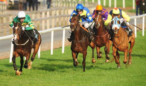 Jezki (left) is pushed out by Tony McCoy to beat Caid Du Berlais and Flaxen Flare (blinkers) 